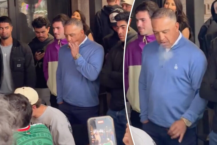 dave-roberts-puffs-on-cigar-while-watching-wing-eating-contest