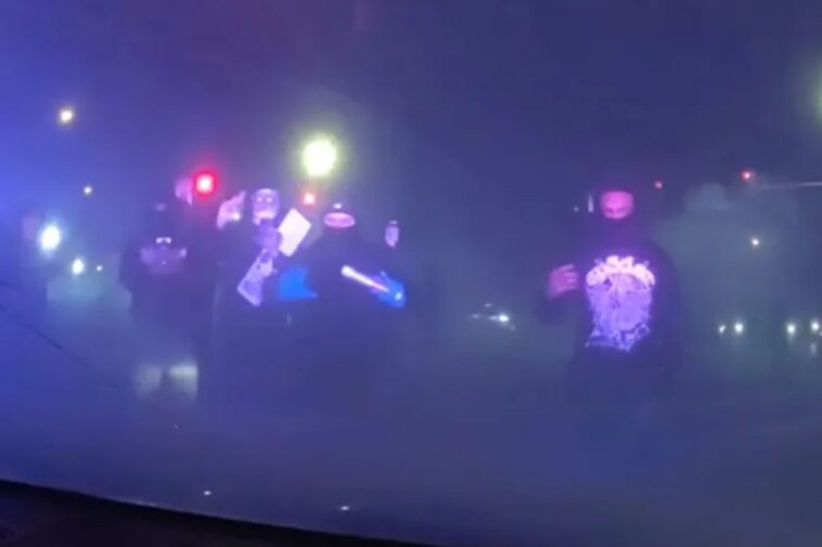 masked-mob-attacks-police-cruiser-with-officer-inside-during-illegal-street-takeover
