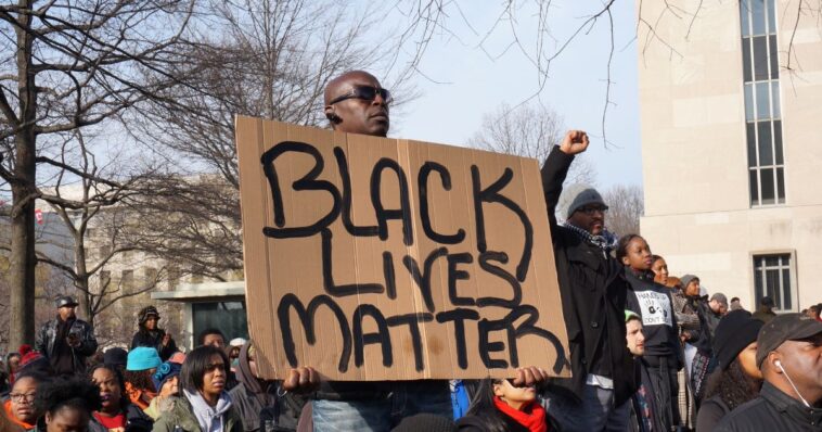 watch:-black-lives-matter-leader-in-black-lives-matter-jacket-fights-black-female-beside-black-lives-matter-banner