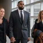 ex-michigan-football-coach-sherrone-moore-walks-into-court-hand-in-hand-with-wife-ahead-of-latest-hearing