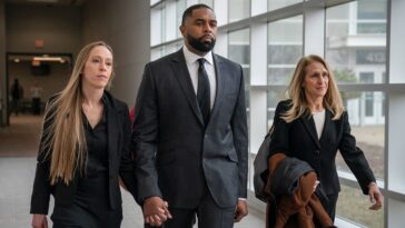 ex-michigan-football-coach-sherrone-moore-walks-into-court-hand-in-hand-with-wife-ahead-of-latest-hearing