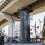 giant-pipe-mysteriously-bursts-through-ground,-rises-30-feet-above-road-in-japan