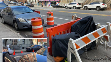 nyc-parking-wars-has-drivers-saving-spots-with-cones,-con-ed-barriers-and-even-derelict-e-bikes