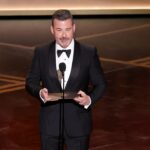 late-night-host-jimmy-kimmel-shows-up-to-‘no-kings’-protest-with-kids,-holds-‘enough-already’-sign