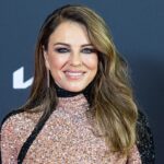 elizabeth-hurley-strips-down-to-bikini-bottoms-for-racy-photo-while-posing-in-a-flower-field