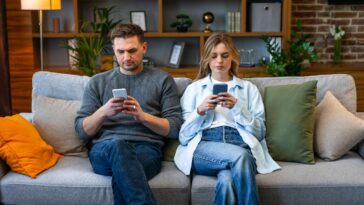 couple-worries-having-a-baby-could-cut-into-time-they-spend-sitting-on-the-couch-staring-at-their-phones