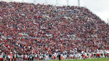skydiver’s-parachute-gets-stuck-on-scoreboard-at-virginia-tech-spring-game-in-harrowing-scene