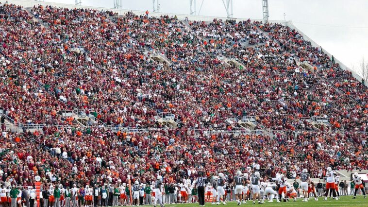 skydiver’s-parachute-gets-stuck-on-scoreboard-at-virginia-tech-spring-game-in-harrowing-scene