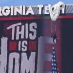 ouch!-parachuter-crashes-into-scoreboard-at-virginia-tech-game,-left-dangling-above-stadium-(video)