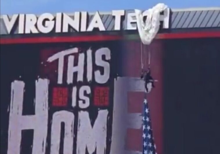 ouch!-parachuter-crashes-into-scoreboard-at-virginia-tech-game,-left-dangling-above-stadium-(video)