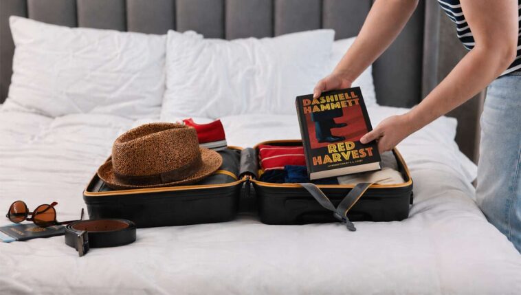 man-packs-book-for-vacation-so-he-can-carry-around-book-on-vacation