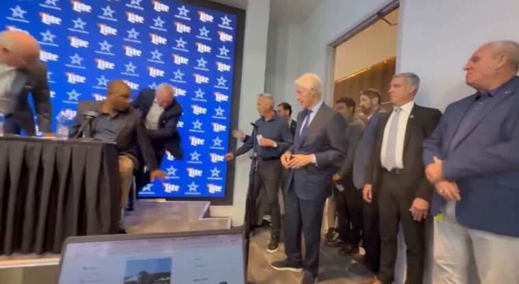 jerry-jones-nearly-falls-off-the-stage-as-bill-clinton-crashes-draft-press-conference-(video)