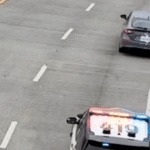 video-shows-alleged-car-thief-dangle-under-bridge-after-wild-chase,-sparking-tense-standoff-with-police