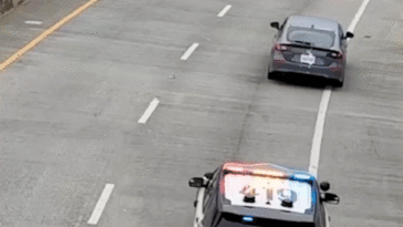 video-shows-alleged-car-thief-dangle-under-bridge-after-wild-chase,-sparking-tense-standoff-with-police