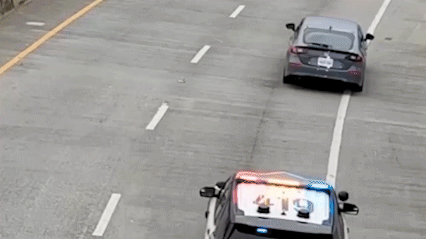 video-shows-alleged-car-thief-dangle-under-bridge-after-wild-chase,-sparking-tense-standoff-with-police