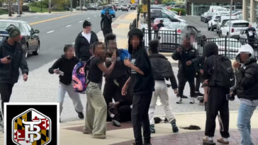 swarm-of-middle-schoolers-laugh,-smile-at-camera-as-brawling-peers-stomp-on-victim-in-wild-street-fight