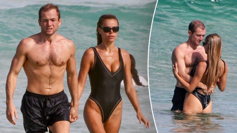 brooks-nader-flaunts-plunging-swimsuit-during-steamy-beach-date-with-actor-taron-egerton-in-australia