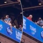 cardinals-fan-dangerously-hangs-off-upper-deck-ledge-in-terrifying-scene