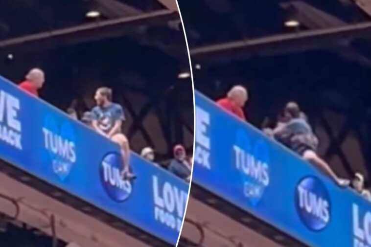 cardinals-fan-dangerously-hangs-off-upper-deck-ledge-in-terrifying-scene