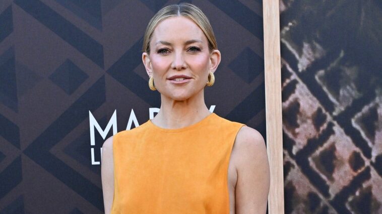 kate-hudson-turns-heads-in-bold-yellow-dress-with-revealing-cutouts-while-on-the-red-carpet