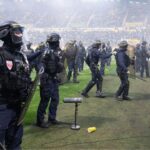 french-football-match-descends-into-chaos-as-furious-nantes-fans-breach-security,-storm-pitch
