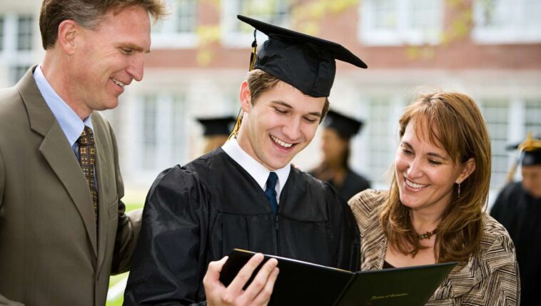 parents-help-graduate-sound-out-the-words-on-diploma