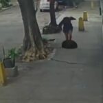 terrifying-moment-woman-falls-down-a-manhole-after-cover-gives-way-beneath-her
