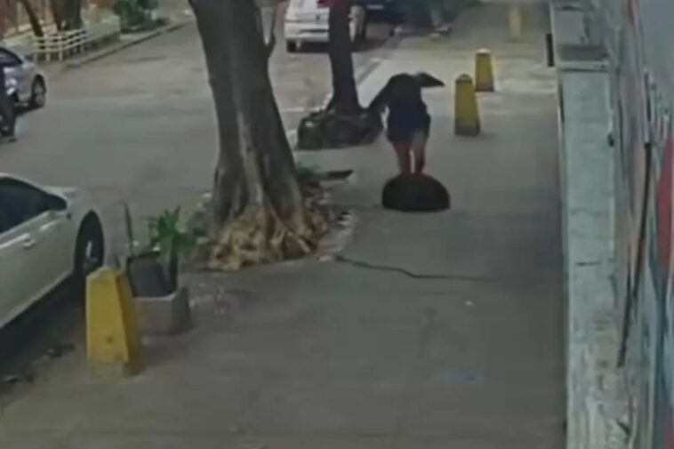 terrifying-moment-woman-falls-down-a-manhole-after-cover-gives-way-beneath-her