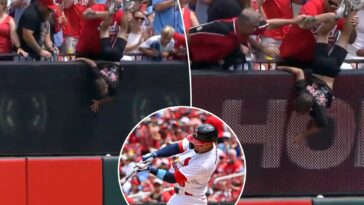 reds-fan-holds-kid-by-legs-in-effort-to-get-home-run-ball-in-wild-scene:-‘going-to-sacrifice-his-son’