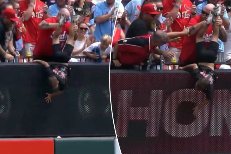 reds-fan-has-strange-defense-for-dangling-child-over-wall