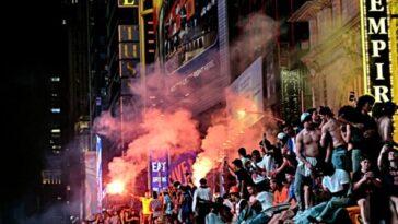 watch-—-times-square:-knicks-fans-torch-school-buses,-light-fireworks-after-nba-win