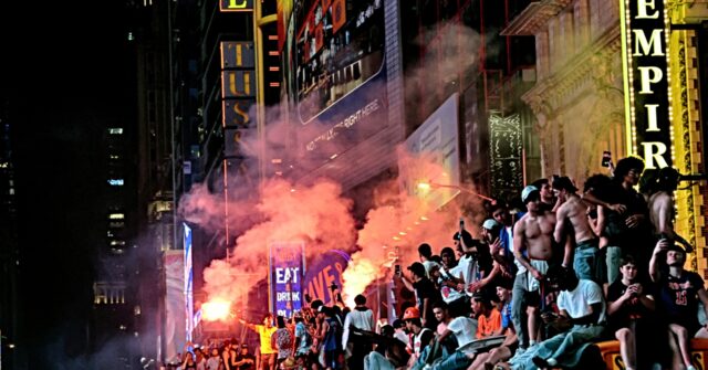 watch-—-times-square:-knicks-fans-torch-school-buses,-light-fireworks-after-nba-win
