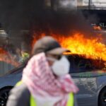 far-leftists-torch-tesla,-smash-shop-windows,-clash-with-cops-at-g7-summit-in-geneva