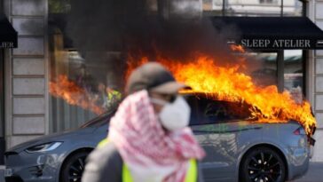 far-leftists-torch-tesla,-smash-shop-windows,-clash-with-cops-at-g7-summit-in-geneva