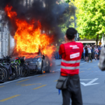 anti-g7-protest-turns-violent-as-demonstrators-torch-tesla-and-smash-un-office-windows