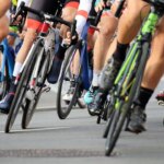 elderly-fan-on-a-mobility-scooter-sends-cyclists-flying-through-the-air-after-driving-onto-course-mid-race