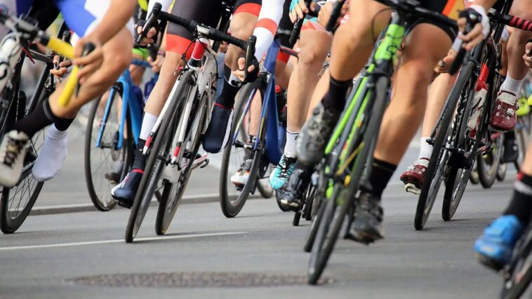 elderly-fan-on-a-mobility-scooter-sends-cyclists-flying-through-the-air-after-driving-onto-course-mid-race