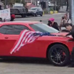 anti-ice-protester-hit-by-car-while-waving-upside-down-us-flag-outside-delaney-hall
