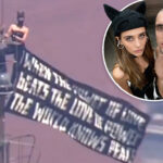 kissing-daredevils-scale-empire-state-building-antenna,-hanging-flag-1,454-feet-over-nyc-with-cringe-message