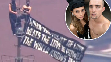 kissing-daredevils-scale-empire-state-building-antenna,-hanging-flag-1,454-feet-over-nyc-with-cringe-message