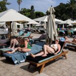tourists-shown-in-stampede-for-pool-lounge-chairs-after-endless-wait-at-holiday-resort