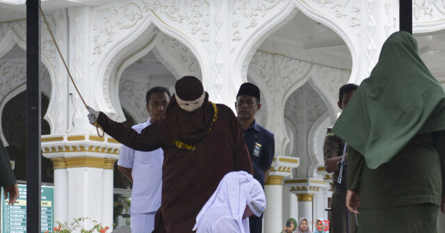 watch-—-sharia-law:-indonesian-woman-collapses-during-flogging-for-kissing-partner-on-tiktok