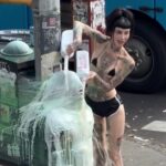 brooklyn-dominatrix-saran-wraps-sub-to-street-pole,-douses-him-in-milk