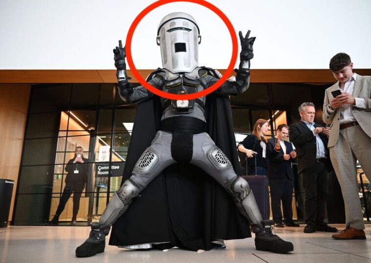 nigel-farage-makes-election-gambit-after-resignation,-now-he-faces-a-man-with-a-trash-can-head