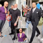 andrew-tate-arrest-video-shows-moment-he-tried-to-give-phone-to-bodyguard-as-he’s-cuffed-by-us-marshals