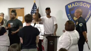 watch-how-police-react-as-screaming-protester-takes-over-briefing-on-fatal-shooting