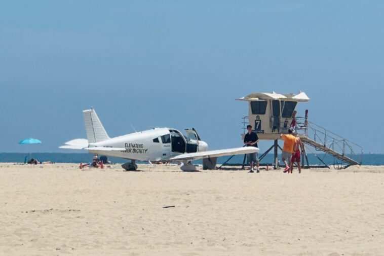 small-plane-makes-emergency-landing-on-sand,-stunning-beachgoers-at-huntington-state-beach