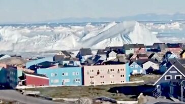 insane-footage-shows-giant-iceberg-collapsing-in-front-of-greenland-settlement,-sending-tsunami-like-waves-towards-the-shore