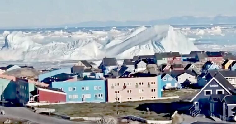 insane-footage-shows-giant-iceberg-collapsing-in-front-of-greenland-settlement,-sending-tsunami-like-waves-towards-the-shore