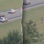 ohio-man-fleeing-police-on-foot-leaps-onto-moving-car,-tries-to-take-control-before-falling-off:-police